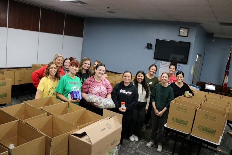 a group of ladies standing by boxes